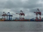Aktifitas-bongkar-muat-peti-kemas-menggunakan-kapal-melalui-pelabuhan-di-sungai-Barito